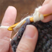 長々編み2目編み入れる[2] 前段の目に針を入れ、長々編みを編みます。